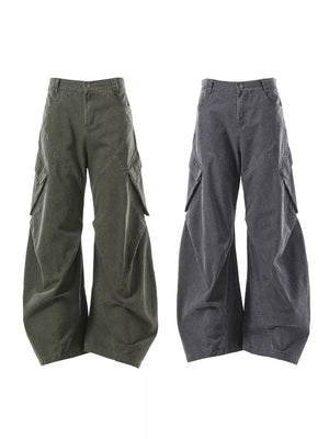 Textured paneled cargo pants in army green and dark gray with baggy fit and large pockets.