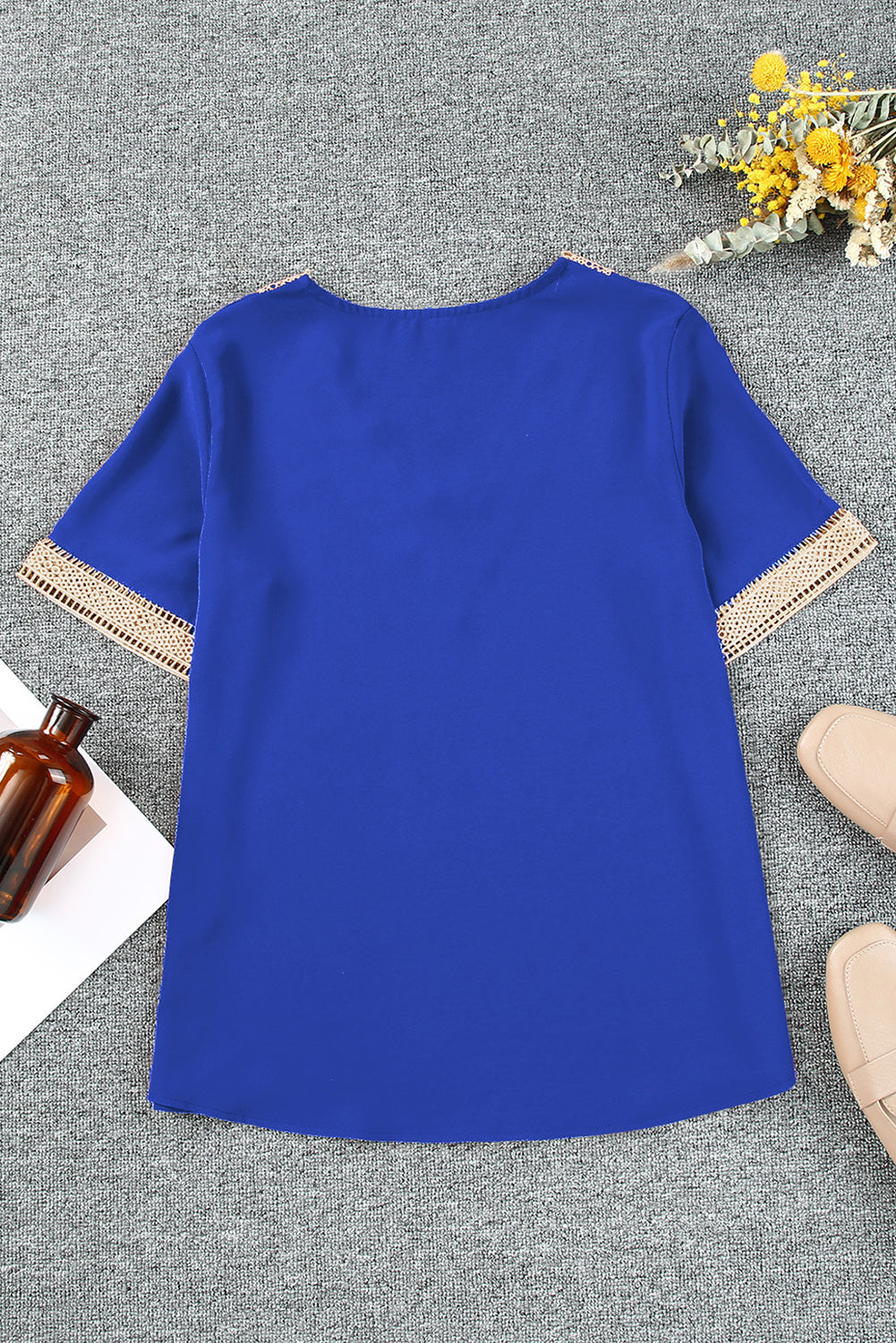 Royal blue blouse with lace trim on V-neckline and short sleeves.