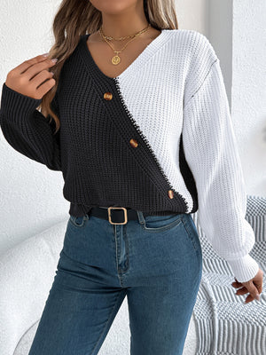 Asymmetrical black and white colorblock knit sweater with button detail