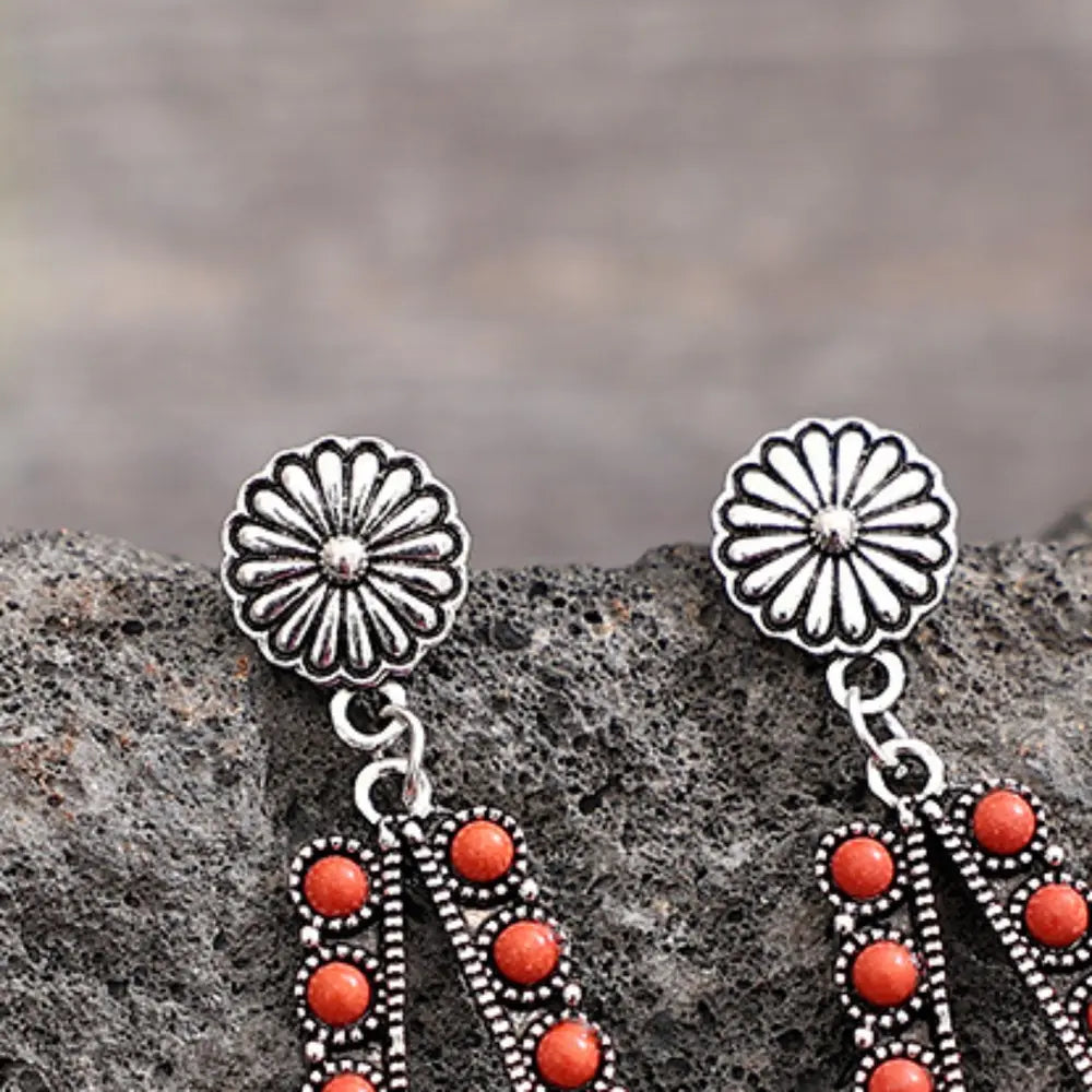 Coral bead teardrop earrings with silver alloy floral studs and beaded trim.