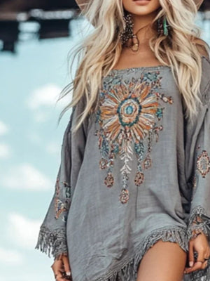 Bohemian gray mini dress with colorful floral embroidery and fringe hem.