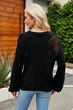 Black knit sweater with open knit detail on sleeves and back, crew neck, long sleeves.