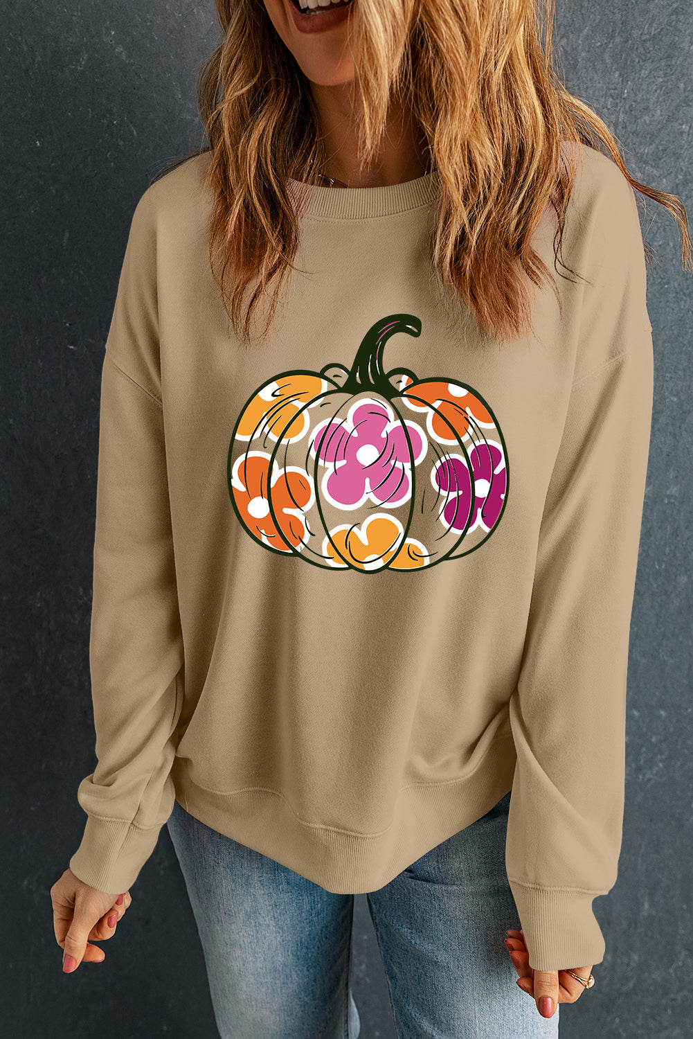 Khaki crewneck sweatshirt with a colorful floral pumpkin graphic, casual autumn style.