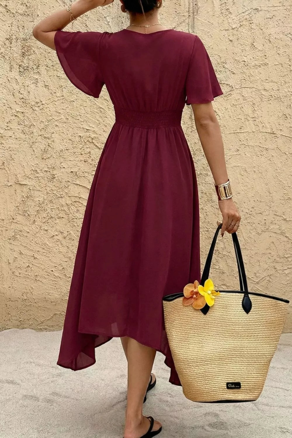 Burgundy V-neck flutter sleeve midi dress with smocked waist and a-line skirt.