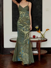 Botanical print spaghetti strap maxi dress with ruched detail and mermaid hem in green.