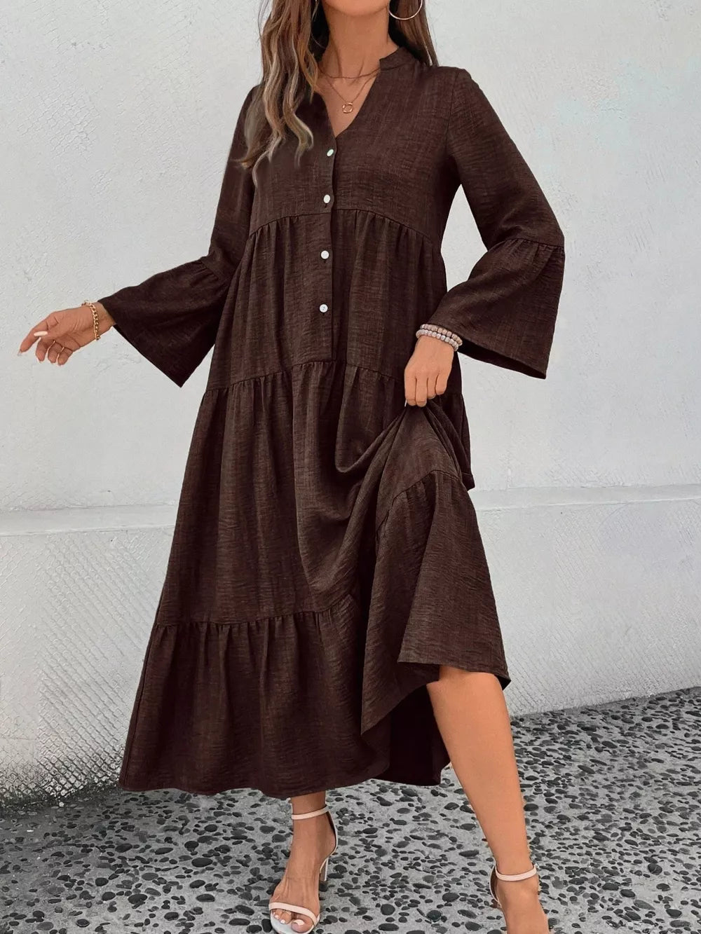 Brown tiered ruffle hem V-neck dress with button front and bell sleeves.