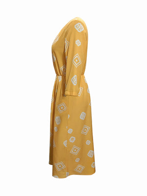 Yellow geometric print empire waist midi dress with 3/4 sleeves.