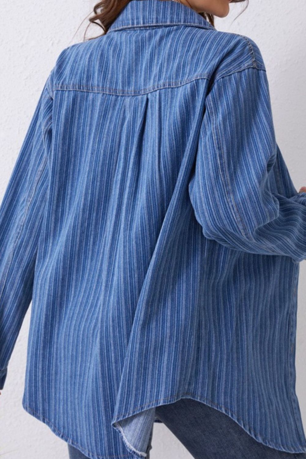 Vertical stripe denim overshirt in medium blue with a collar and button-front style.