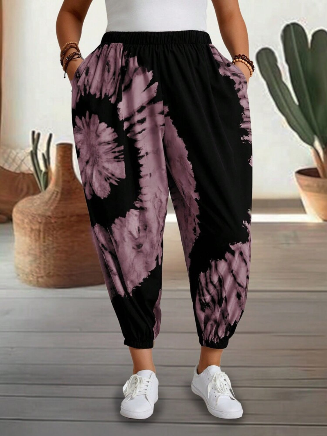Tie-dye harem trousers in dusty pink and black with elastic waist and cuffed ankles.
