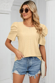 Perforated puff sleeve top in light yellow with a textured pattern and round neckline.