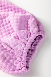 Textured quilted puff sleeve blouse in pink purple with gathered cuff detail.