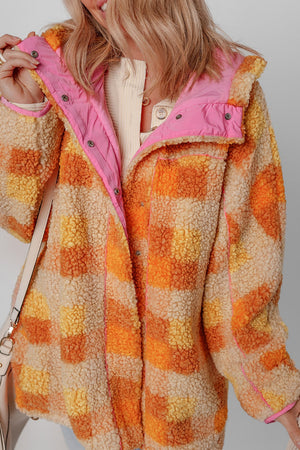 Checkerboard sherpa jacket in tangerine with contrast pink collar and snap button closure.