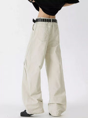 Men's oversized wide-leg jeans in off-white cotton with a black grommet belt.