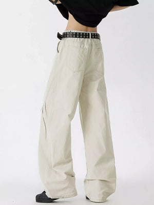Men's oversized wide-leg jeans in off-white cotton with a black grommet belt.