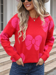 Red acrylic sweater with pink bow pattern, crew neck, long sleeves.