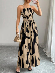Maxi dress with halter neck, abstract print, and belted waist in khaki and black.