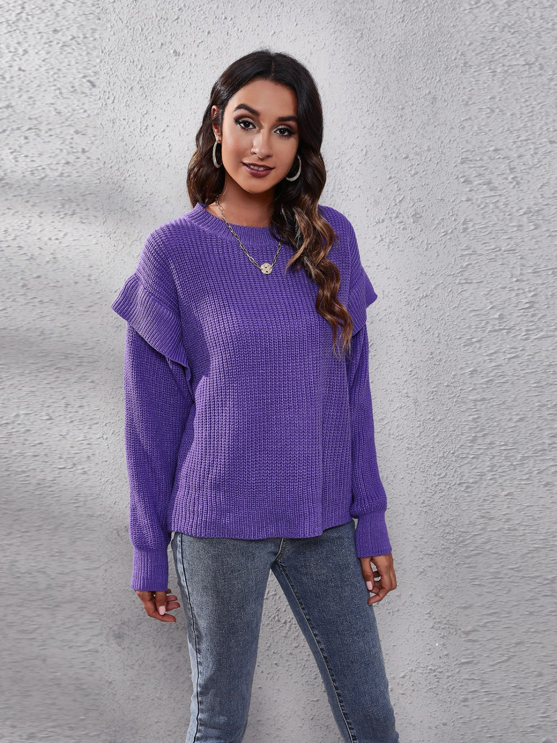 Violet ribbed knit pullover sweater with ruffled sleeves.