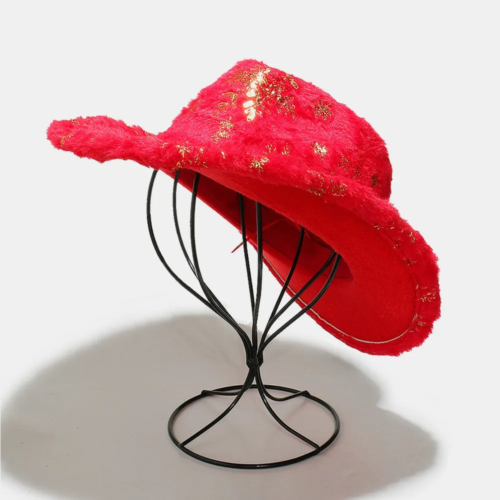 Crimson faux fur cowboy hat with gold floral accents, displayed on a stand.
