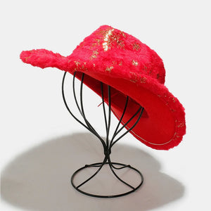 Crimson faux fur cowboy hat with gold floral accents, displayed on a stand.