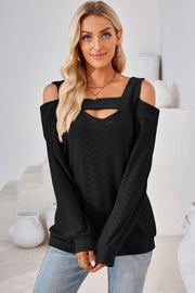 Black geometric cutout shoulder top with square neckline and long sleeves.