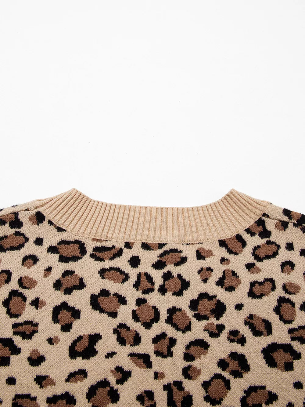 Beige leopard print knit sweater with crew neck and ribbed collar.