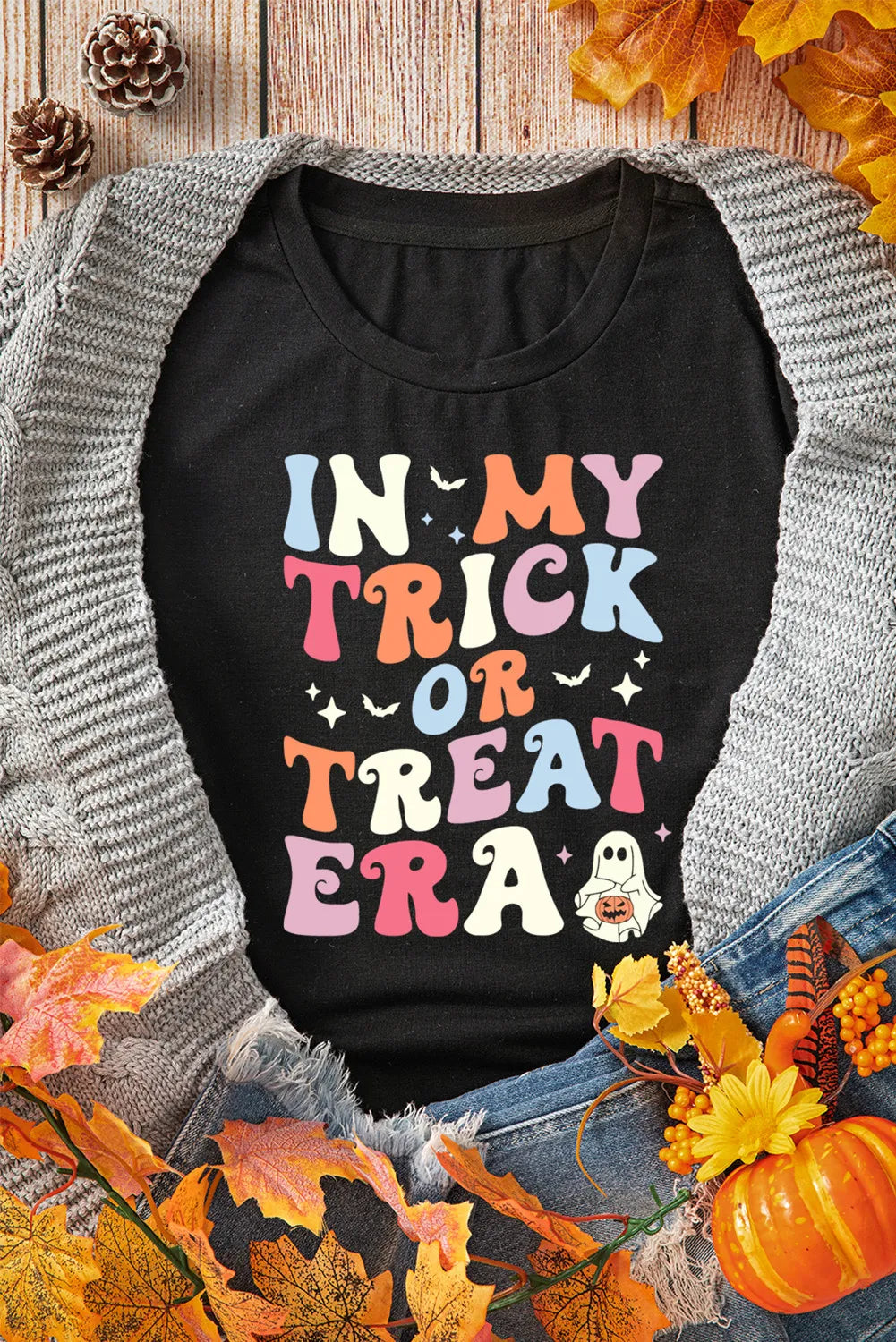 Black graphic t-shirt with colorful "In My Trick or Treat Era" text and a ghost graphic.