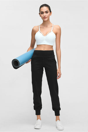 Black jogger fit performance trousers with pockets and cuffed ankles.