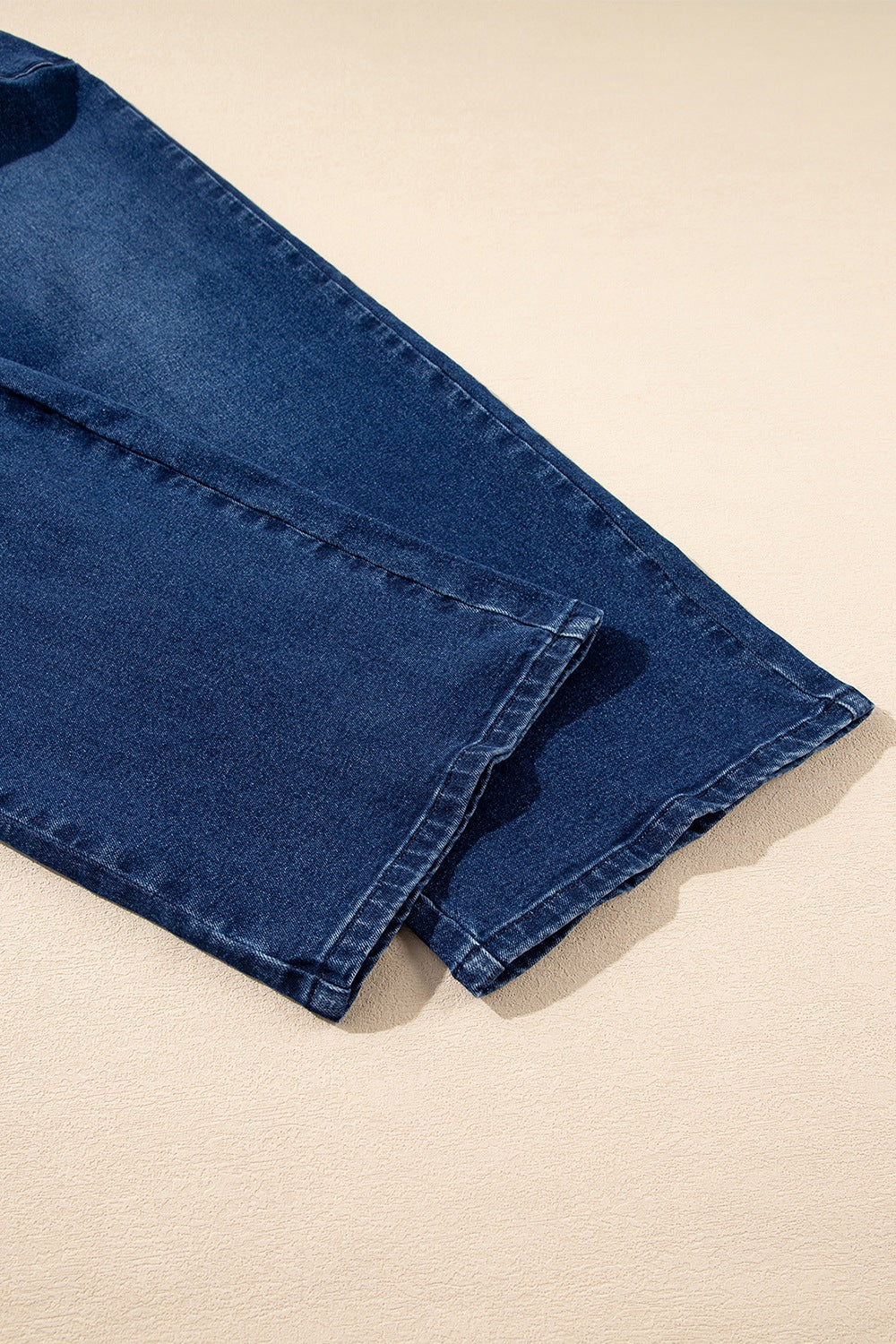 Mid-rise straight leg jeans in dark wash denim with visible stitching detail.