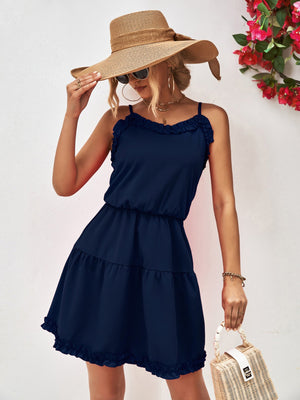 Dark blue camisole mini dress with ruffled tiers and spaghetti straps.