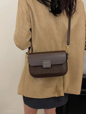 Chic two-tone crossbody bag in coffee brown with suede panel and square clasp.