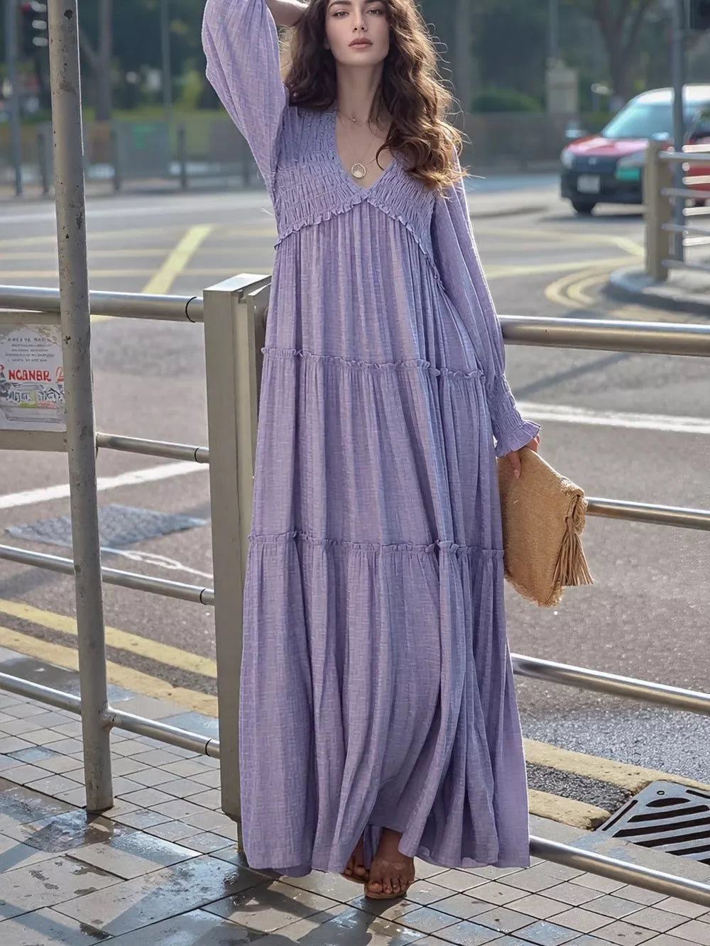 Purple smocked V-neck tiered maxi dress with long sleeves and a flowy skirt.