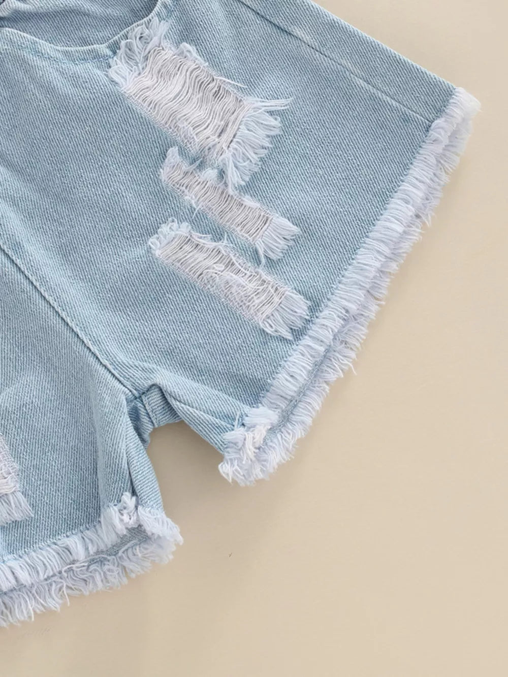 Light wash denim shorts with distressed rips and frayed hem detail.