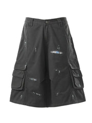 Black distressed cargo capris with multiple pocket details and plaid lining accents.