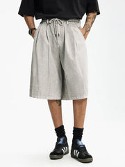 Light gray cotton wide-leg chino shorts for men with drawstring waist and pleats.