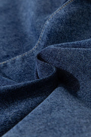 Denim wrap skort in medium wash with visible stitching and texture.