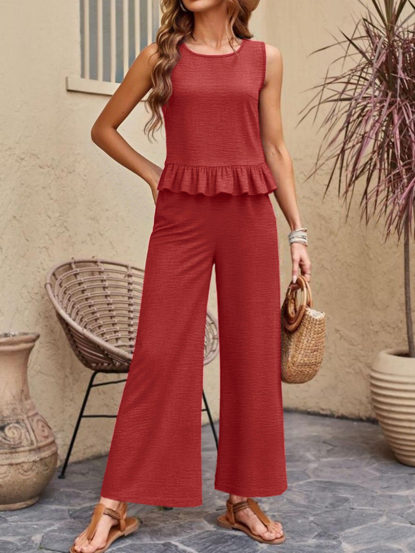 Red ruffled hem sleeveless top and wide-leg pants set with textured fabric.