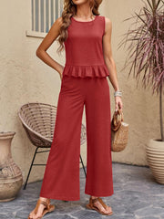 Red ruffled hem sleeveless top and wide-leg pants set with textured fabric.