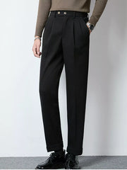 Men's black tailored pleated dress pants with cuffed hems.