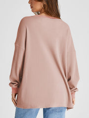 Pale blush waffle knit raglan sleeve sweatshirt with crew neck and relaxed fit.