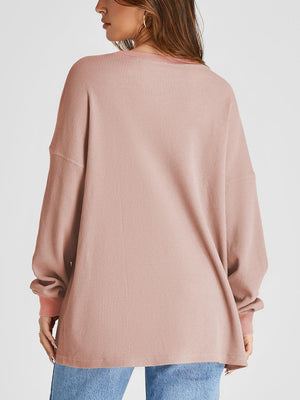 Pale blush waffle knit raglan sleeve sweatshirt with crew neck and relaxed fit.