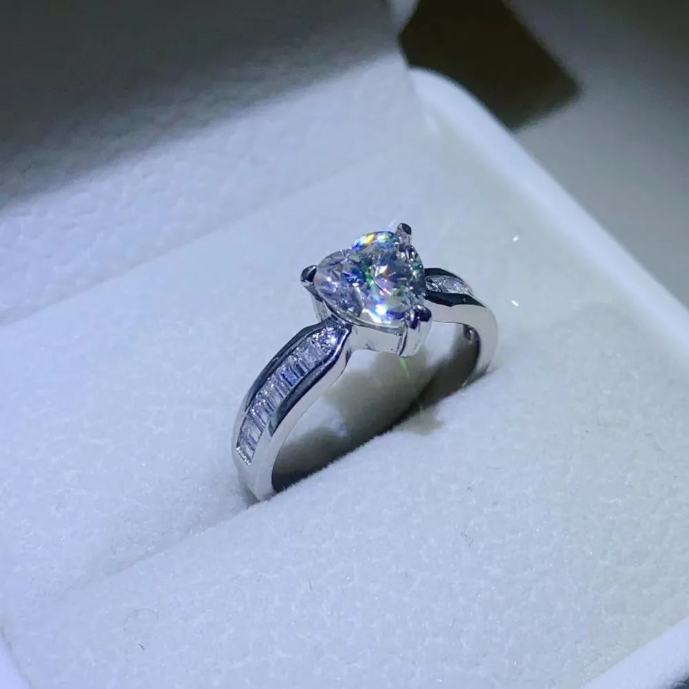 Silver ring with heart-cut moissanite and baguette accents