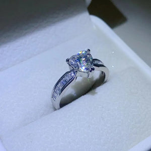 Silver ring with heart-cut moissanite and baguette accents