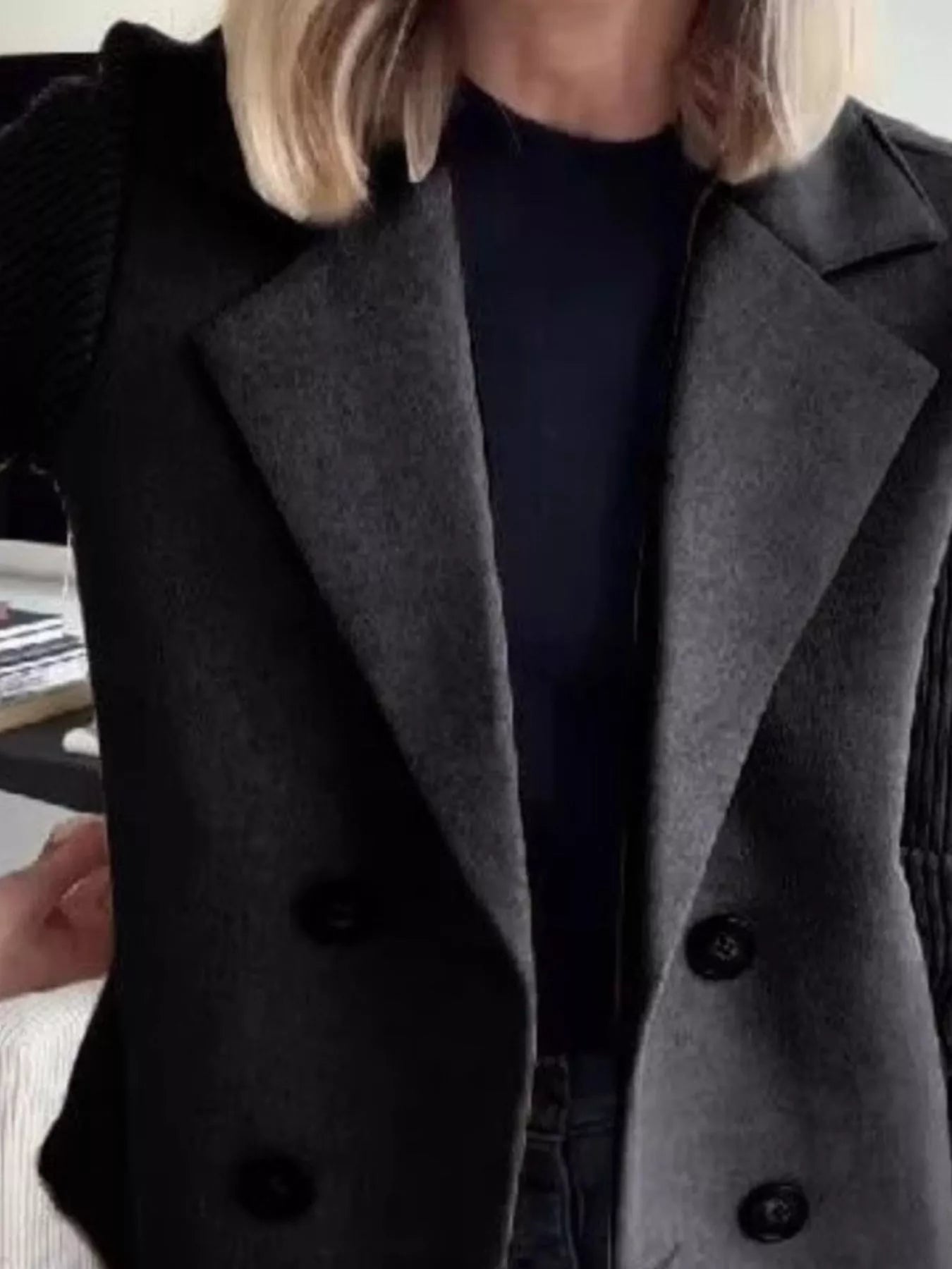Double-breasted gray wool blend blazer with black buttons and textured sleeves.