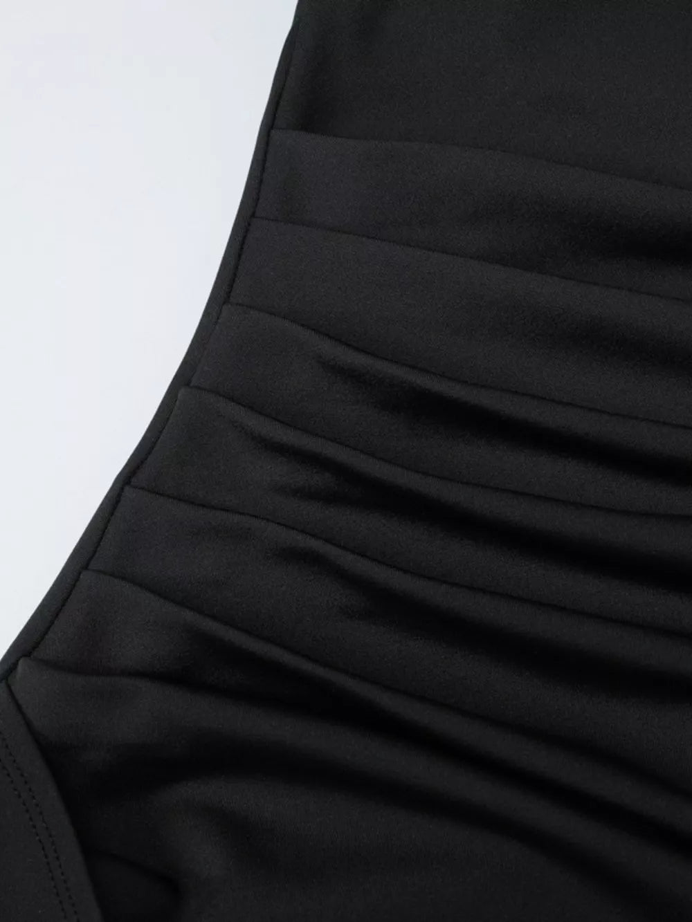 Black ruched maxi dress detail with elastane fabric.