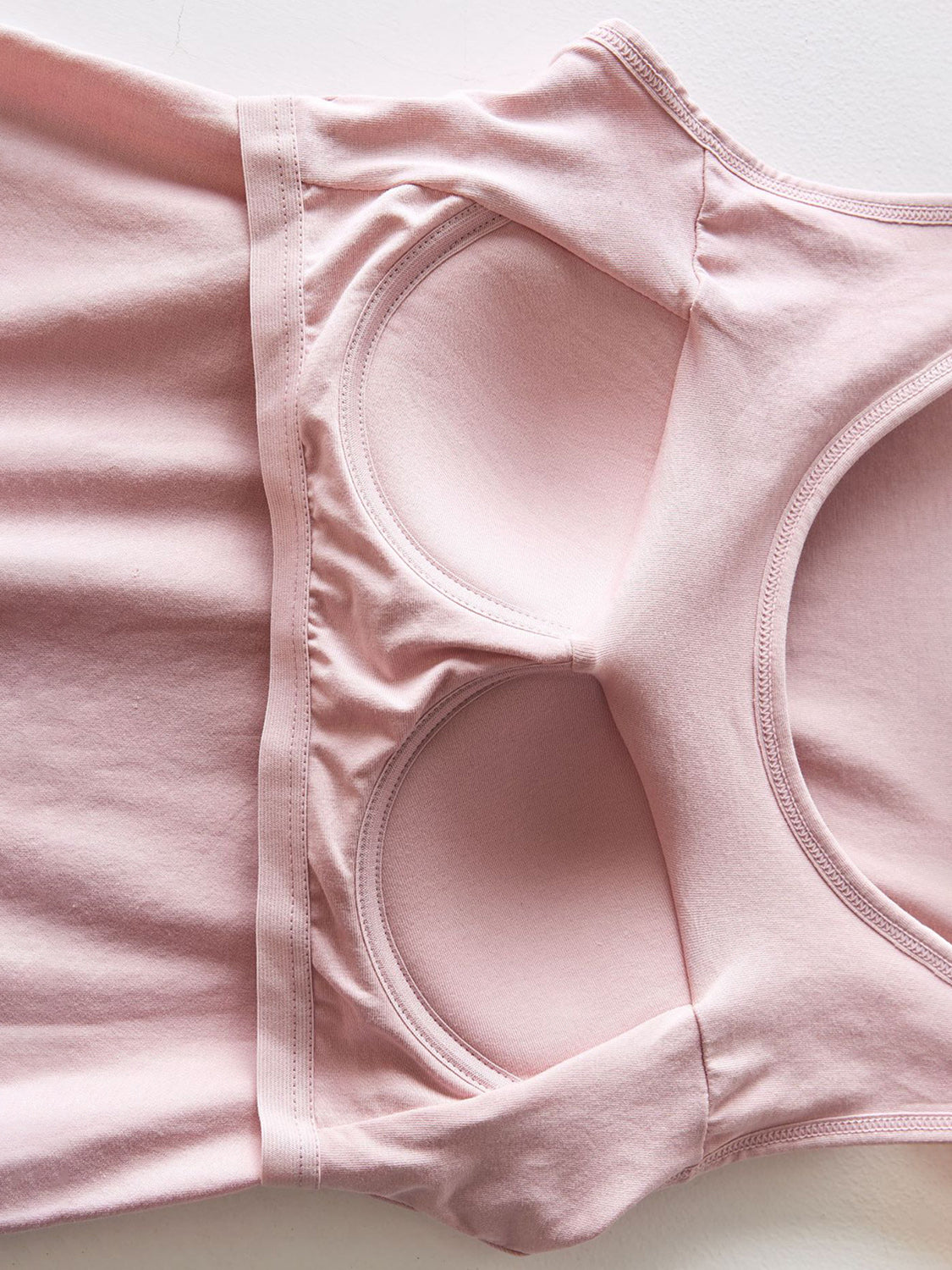 Pale Blush Built-In Support Tank Top with built-in bra cups and elastic band detail.