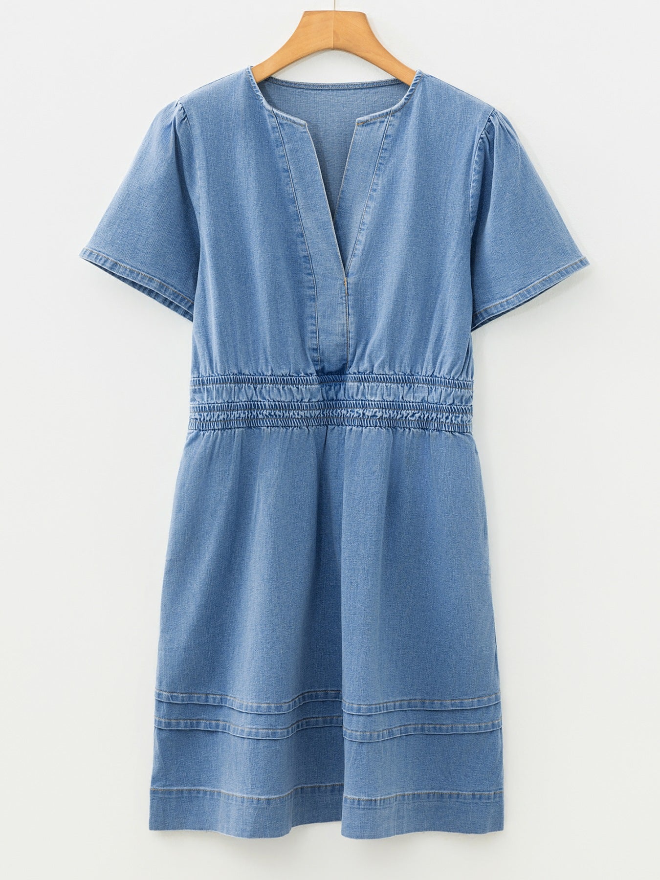 Chic denim dress with V-neck, short sleeves, elastic waist, and tiered hem.