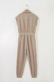 Chic collared zip front romper in tan with cap sleeves and ankle cuffs.