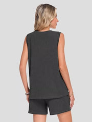 Black ribbed knit set with sleeveless top and shorts, featuring pockets.