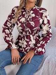 Burgundy floral peplum blouse with ruffled neck and tie detail