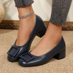Dark blue buckle block heel shoes with square toe detail.